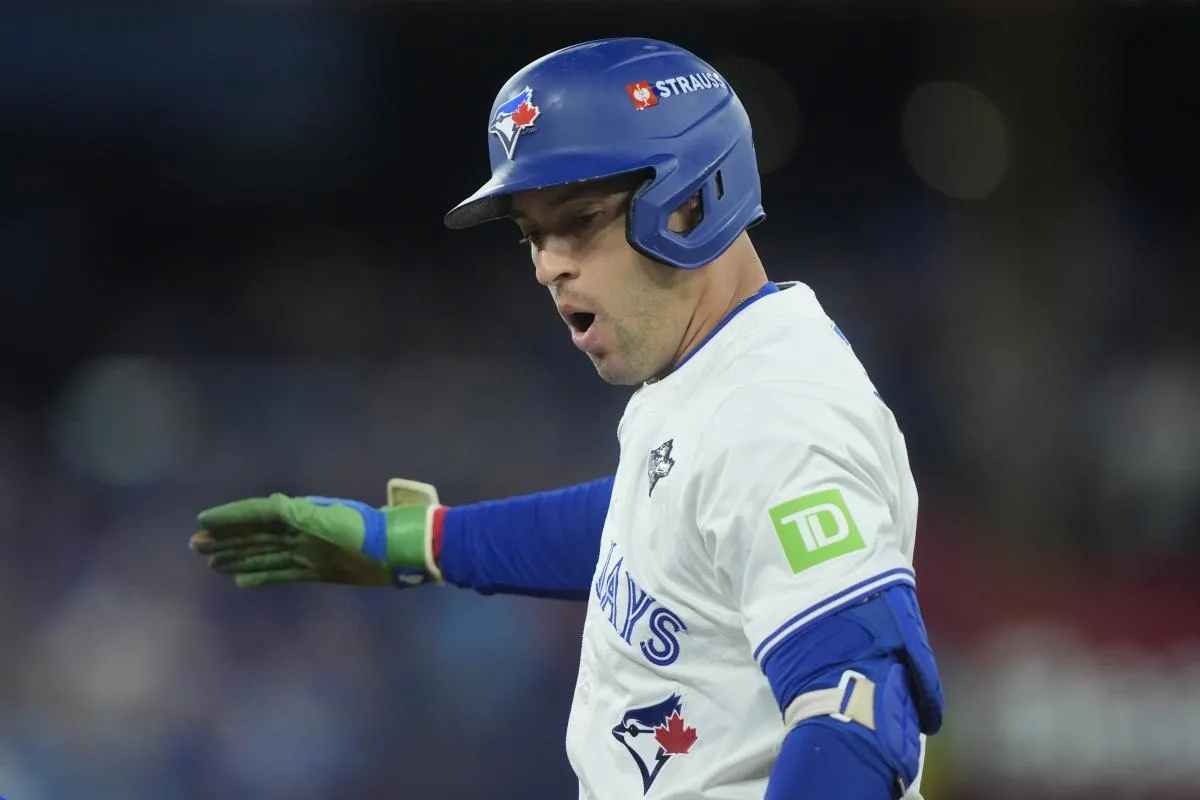 Toronto Blue Jays right fielder George Springer (4) reacts after hitting a single against the Los Angeles Dodgers in the first inning during game seven of the 2025 MLB World Series at Rogers Centre.