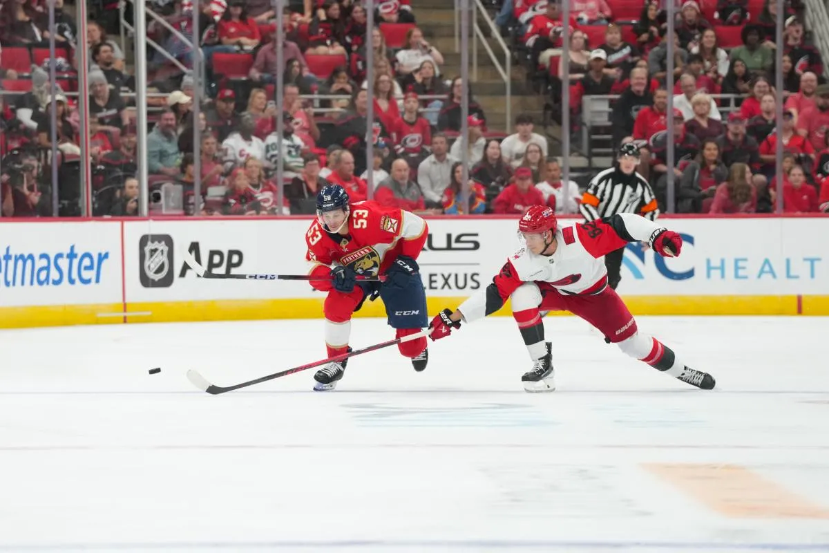 Florida Panthers center Jack Studnicka (53) and Carolina Hurricanes center Ryan Suzuki (16) skate after the puck during the second period at Lenovo Center.