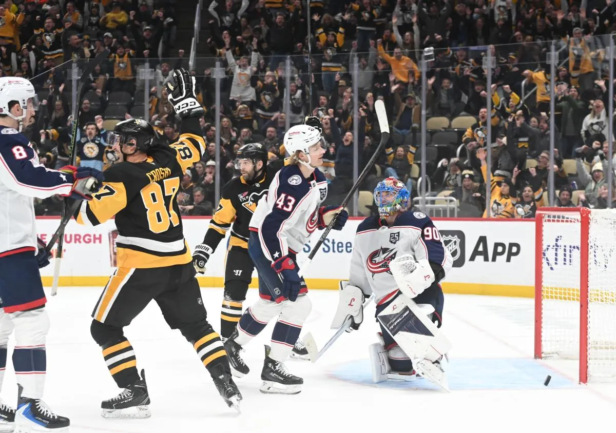 Pittsburgh Penguins center Sidney Crosby (87) scores on Columbus Blue Jackets goalie Elvis Merzlikins (90) in the final minute of the third period at PPG Paints Arena. Columbus won 4-3 in a shoot out.