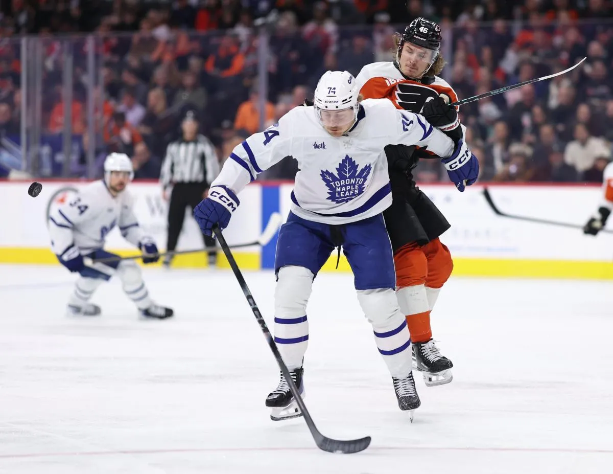 Toronto Maple Leafs center Bobby McMann (74) and Philadelphia Flyers center Trevor Zegras (46) battle for the puck during the second period at Xfinity Mobile Arena.