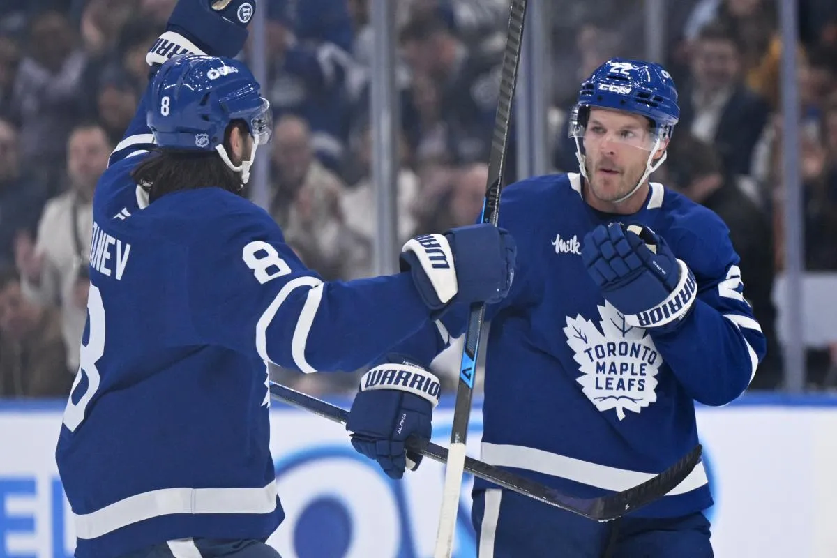 Toronto Maple Leafs defenseman Jake McCabe (22) celebrates with defenseman Chris Tanev (8) after scoring a goal against the Nashville Predators in the first period at Scotiabank Arena.
