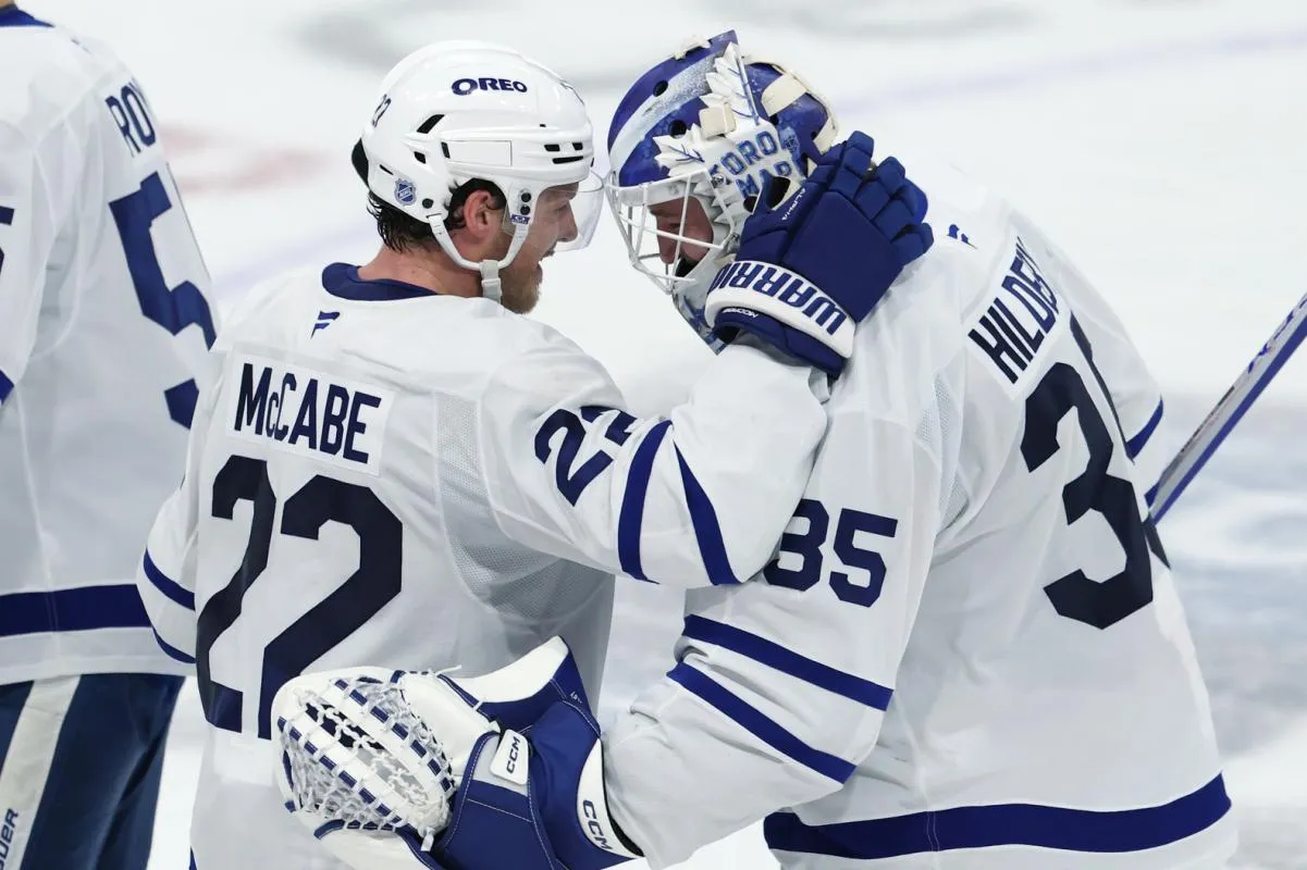 Toronto Maple Leafs defenseman Jake McCabe (22) and Toronto Maple Leafs goaltender Dennis Hildeby (35) celebrate their victory over the Winnipeg Jets at Canada Life Centre.
