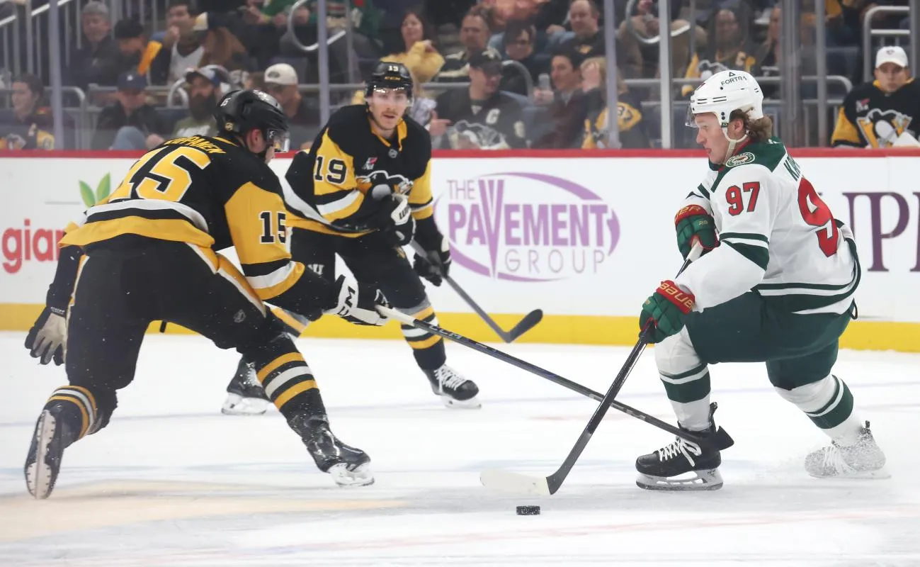 Minnesota Wild left wing Kirill Kaprizov (97) skates with the puck against Pittsburgh Penguins left wing Joona Koppanen (15) during the first period at PPG Paints Arena.
