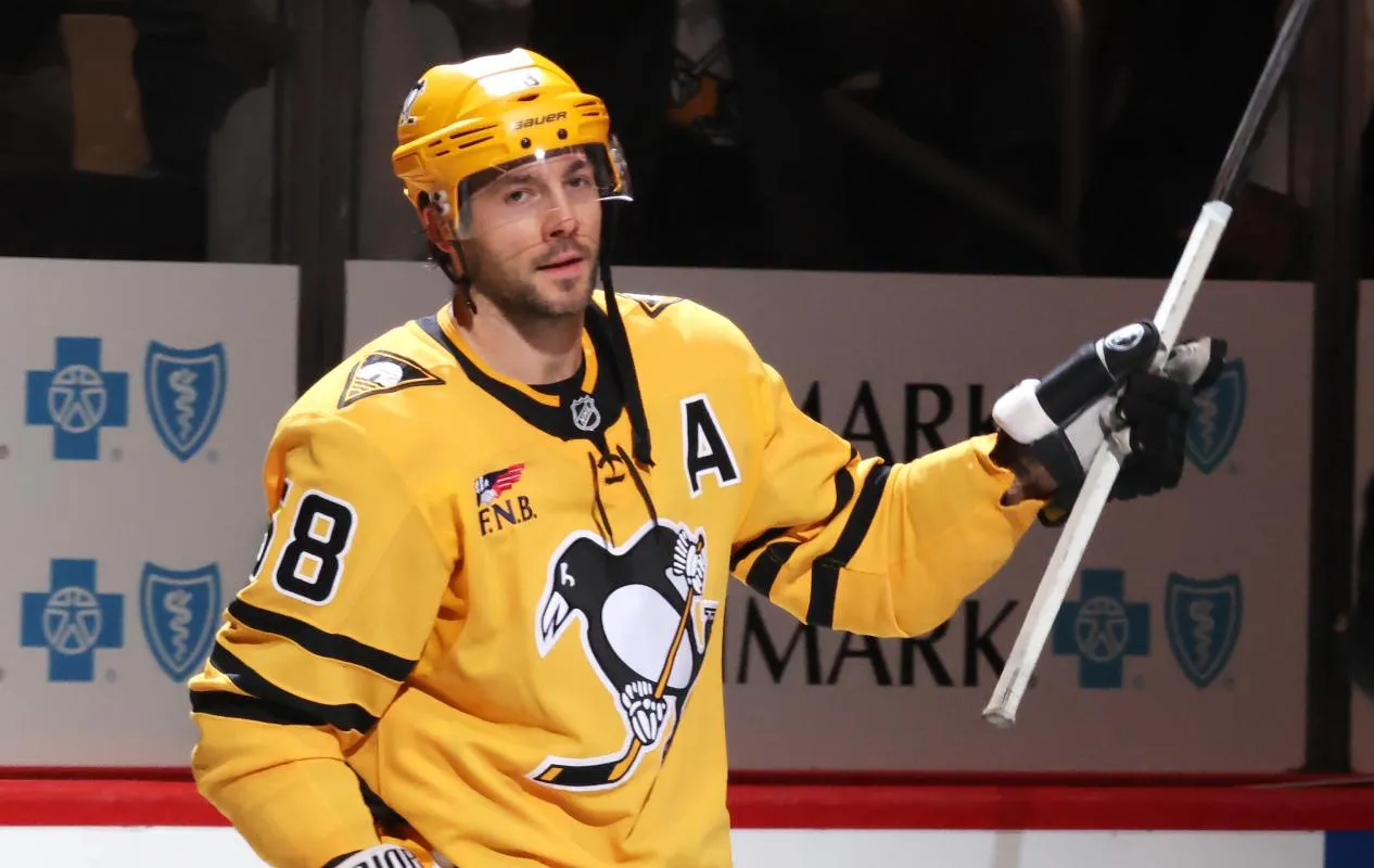 Pittsburgh Penguins defenseman Kris Letang (58) reacts after being named first star of the game after scoring the game winning goal during overtime in his 1200th career NHL contest to defeat the Detroit Red Wings at PPG Paints Arena.