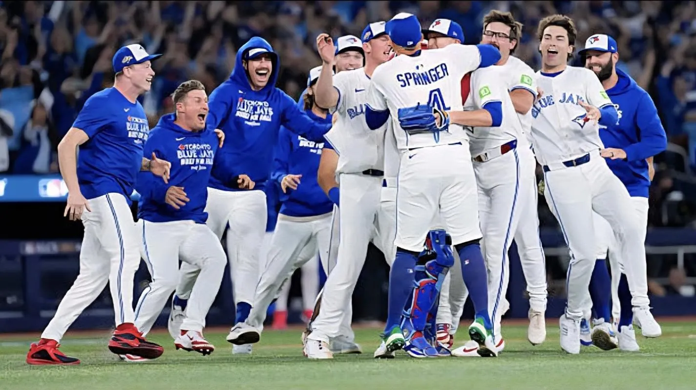 October 20, 2025: Toronto Blue Jays players celebrate on the field after defeating the Seattle Mariners in game seven of the American League Championship Series at the Rogers Centre in Toronto, Ontario.