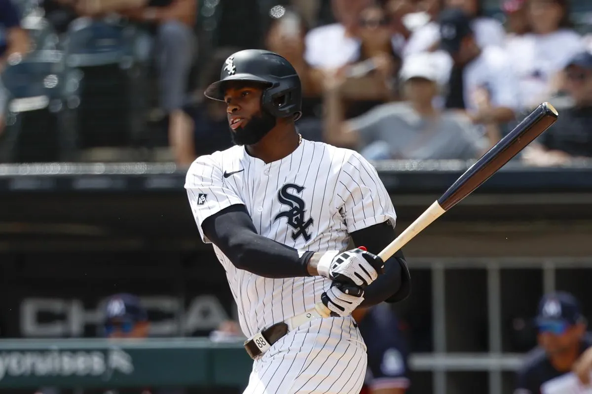 Chicago White Sox center fielder Luis Robert Jr. (88) singles against the Minnesota Twins during the first inning at Rate Field.