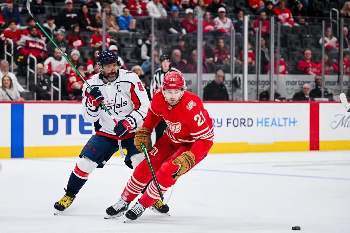 Washington Capitals left wing Alex Ovechkin (8) and Detroit Red Wings left wing James van Riemsdyk (21) battle for the puck during the third period at Little Caesars Arena.