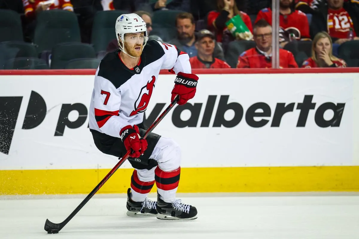 New Jersey Devils defenseman Dougie Hamilton (7) skates with the puck against the Calgary Flames during the overtime period at Scotiabank Saddledome.