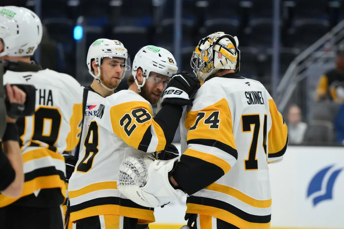 Pittsburgh Penguins defenseman Parker Wotherspoon (28) and goaltender Stuart Skinner (74) celebrate after defeating the Seattle Kraken during the third period at Climate Pledge Arena.