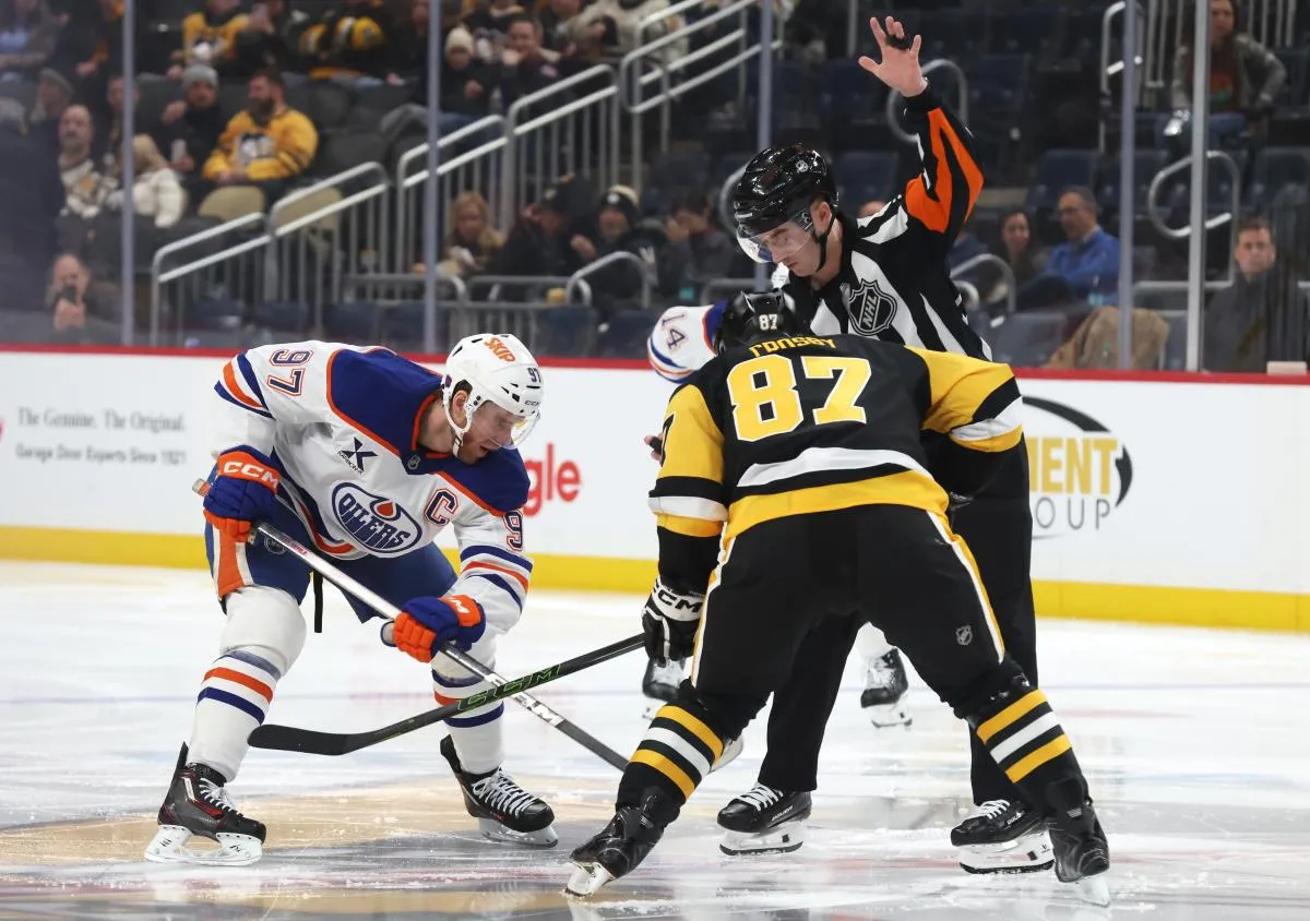 Edmonton Oilers center Connor McDavid (97) and Pittsburgh Penguins center Sidney Crosby (87) take a second period face-off at PPG Paints Arena.