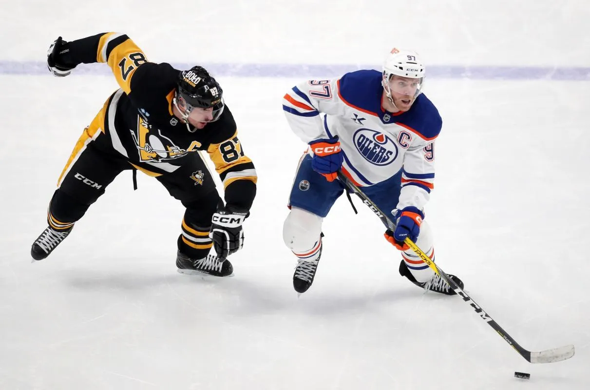 Edmonton Oilers center Connor McDavid (97) skates with the puck around Pittsburgh Penguins center Sidney Crosby (87) during the third period at PPG Paints Arena.