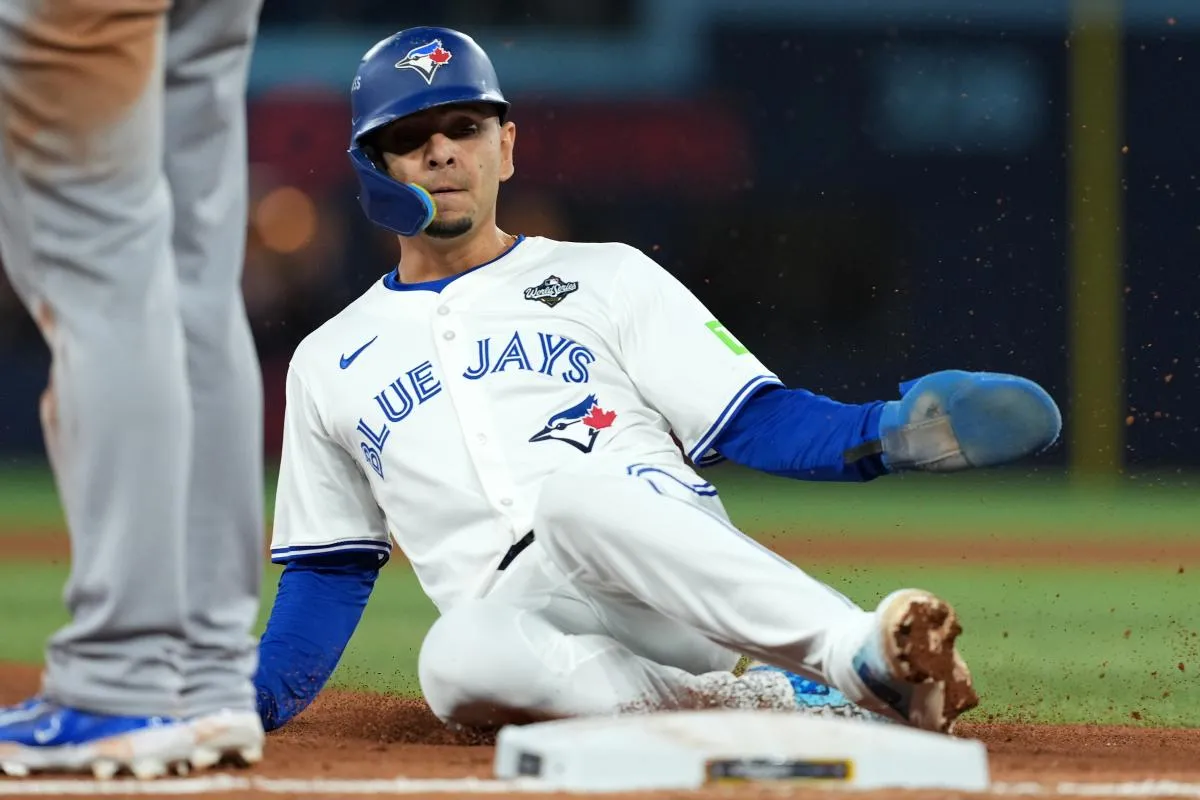 Toronto Blue Jays second basemen Andres Gimenez (0) slides into third base in the sixth inning for game seven of the 2025 MLB World Series at Rogers Centre.