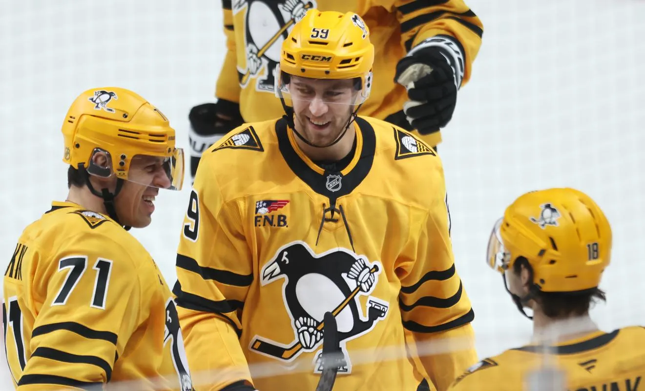 Pittsburgh Penguins right wing Egor Chinakhov (59) celebrates his goal with Pittsburgh Penguins center Evgeni Malkin (71) and center Tommy Novak (18) against the Philadelphia Flyers during the second period at PPG Paints Arena.