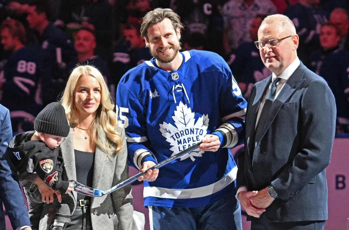 Toronto Maple Leafs defenseman Oliver Ekman-Larsson (95) with his family is presented with a silver stick by club general manager Brad Treliving to commemorate playing 1,000 NHL games before a game against the Edmonton Oilers at Scotiabank Arena.