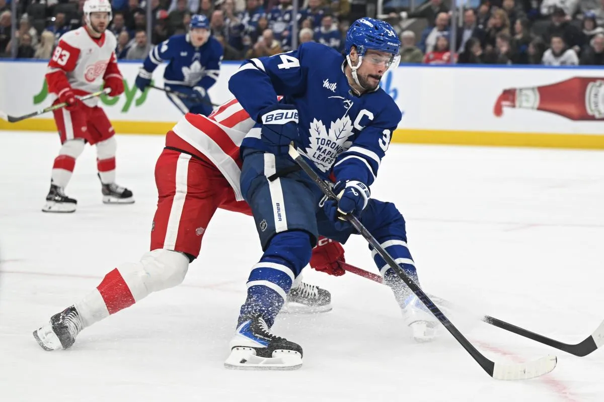 Toronto Maple Leafs forward Auston Matthews (34) moves the puck past Detroit Red Wings defenseman Albert Johansson (20) in the third period at Scotiabank Arena
