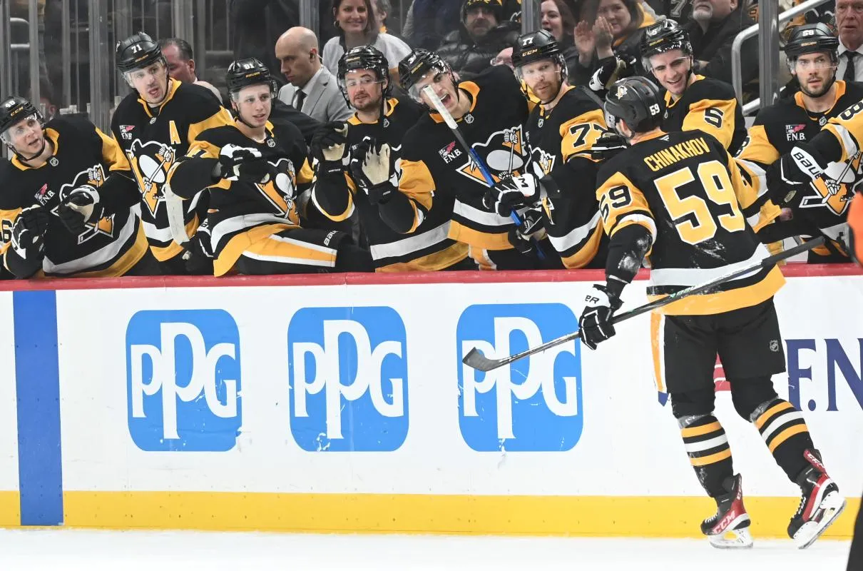 Pittsburgh Penguins right wing Egor Chinakhov (59) is greeted by his teammates after scoring on the Columbus Blue Jackets at PPG Paints Arena.