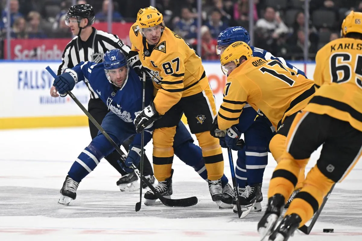 Pittsburgh Penguins forward Sidney Crosby (87) wins a faceoff against Toronto Maple Leafs forward John Tavares (91) in the third period at Scotiabank Arena.