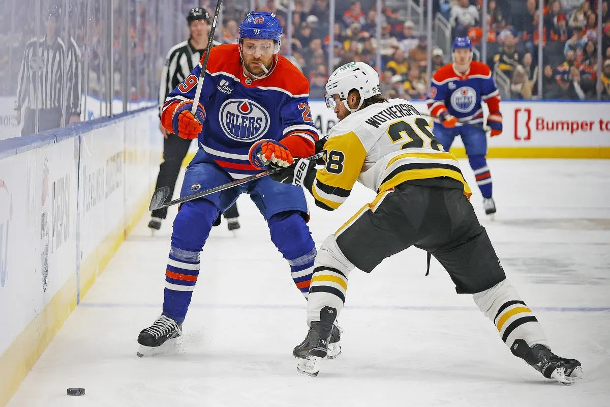 Pittsburgh Penguins defensemen Parker Wortherspoon (28) tries to knock Edmonton Oilers forward Leon Draisaitl (29) off the puck during the first period at Rogers Place.