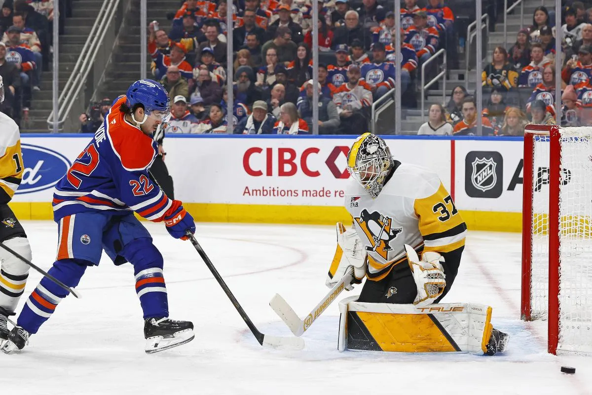 Pittsburgh Penguins goaltender Arturs Silovs (37) makes a save on on Edmonton Oilers forward Matt Savoie (22) during the third period at Rogers Place.