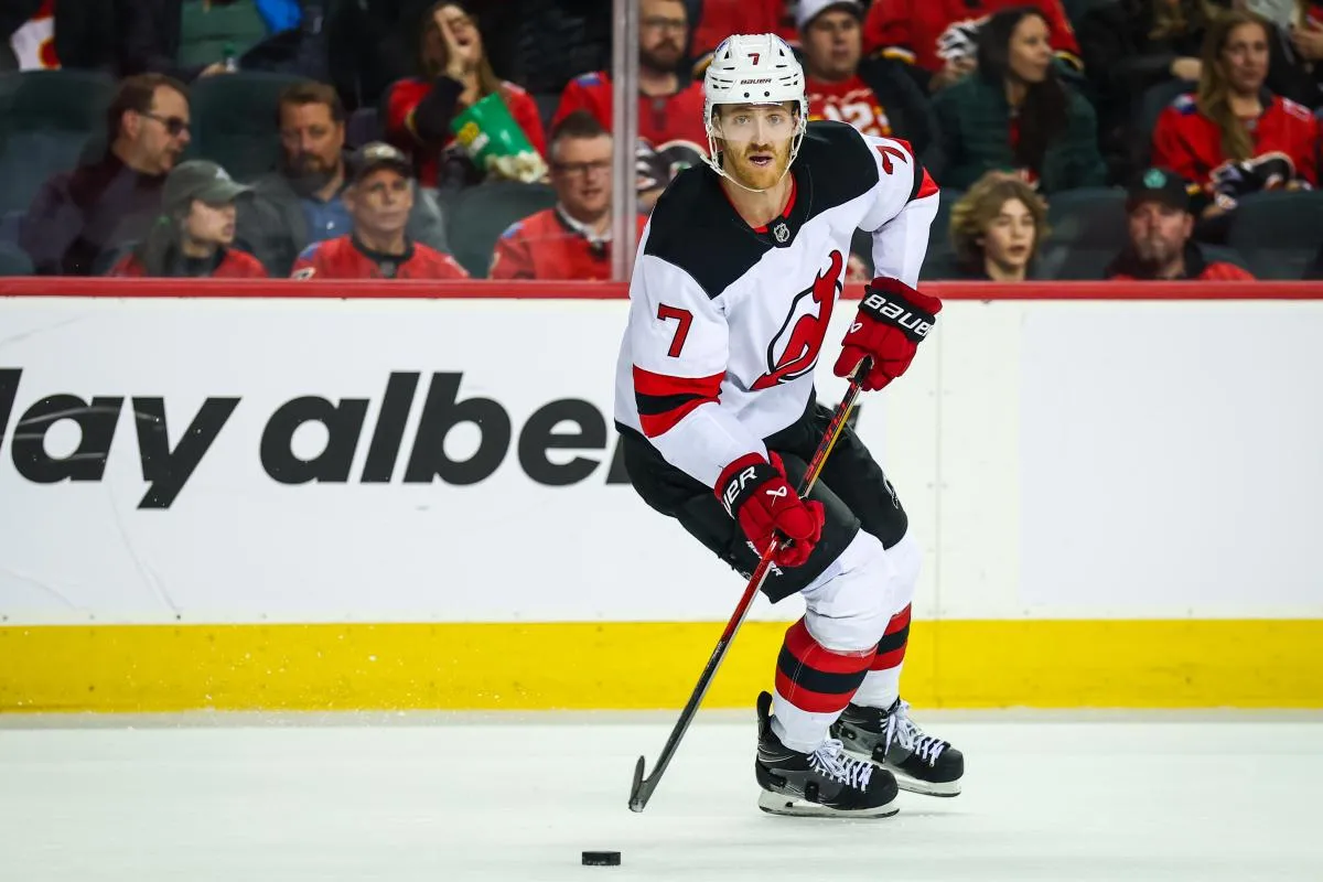 New Jersey Devils defenseman Dougie Hamilton (7) skates with the puck against the Calgary Flames during the overtime period at Scotiabank Saddledome.