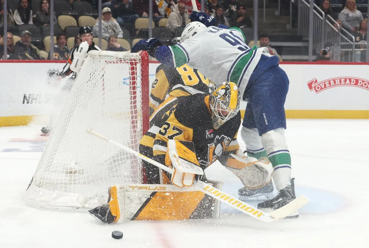 Pittsburgh Penguins goaltender Arturs Silovs (37) makes a save against Vancouver Canucks left wing Evander Kane (91) during the first period at PPG Paints Arena.