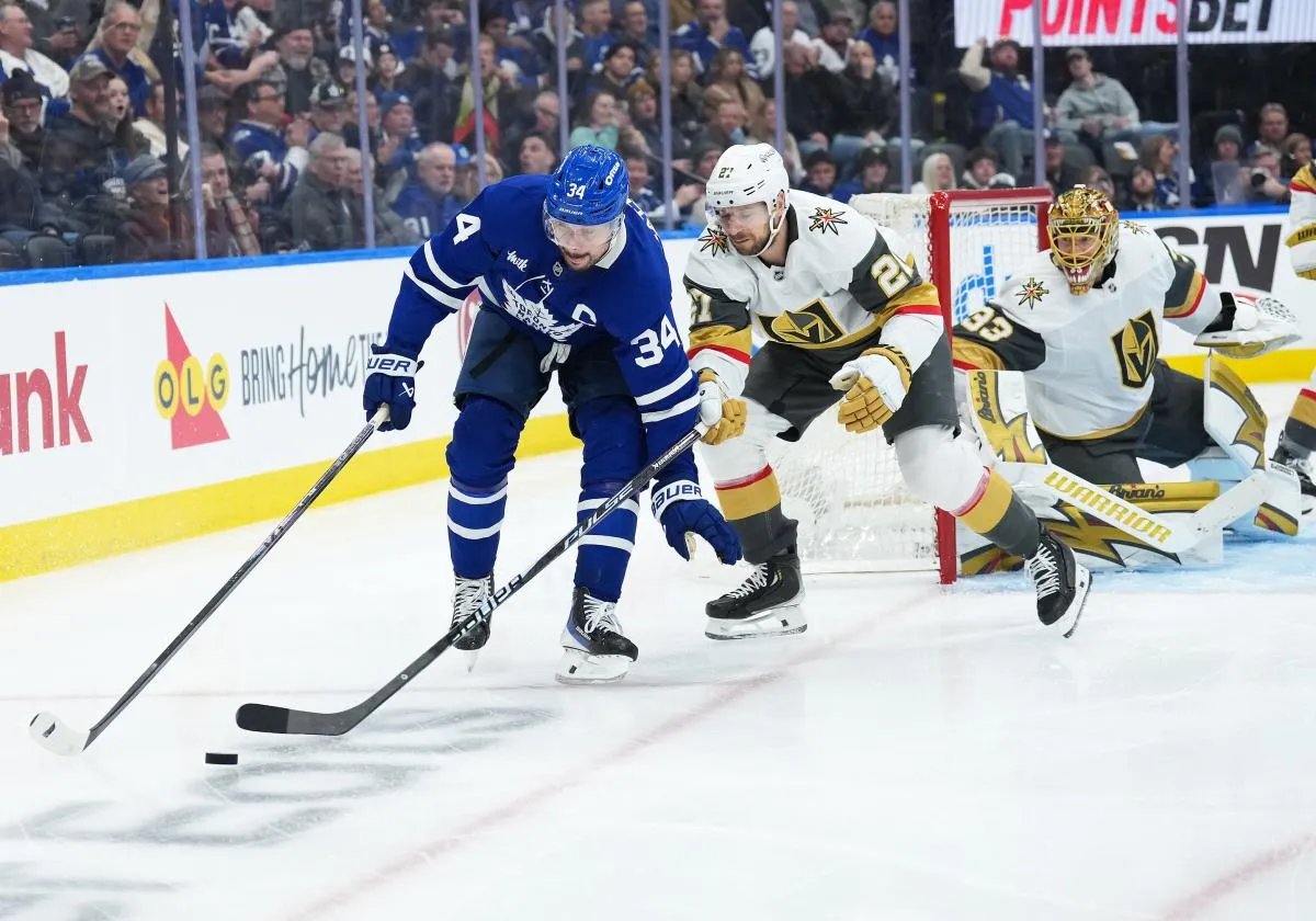 Toronto Maple Leafs center Auston Matthews (34) battles for the puck with Vegas Golden Knights defenseman Shea Theodore (27) during the third period at Scotiabank Arena