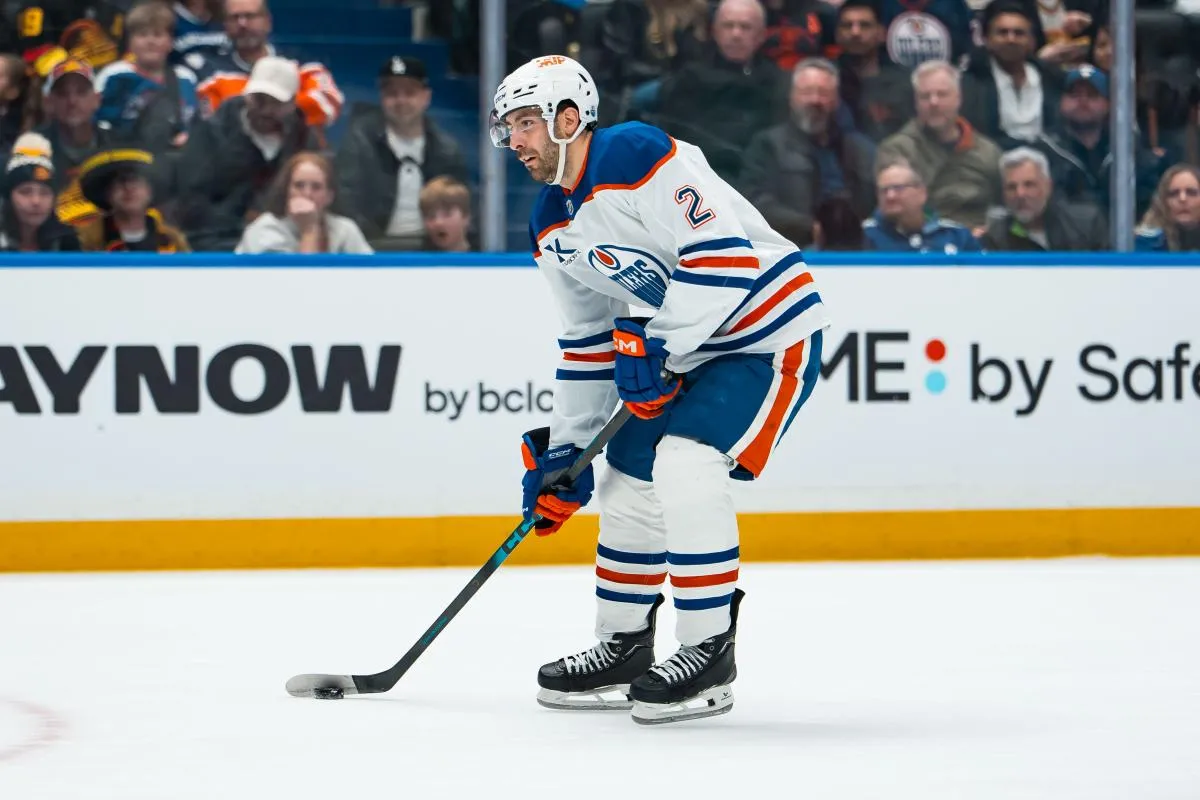 Edmonton Oilers defenseman Evan Bouchard (2) handles the puck against the Vancouver Canucks in the first period at Rogers Arena.