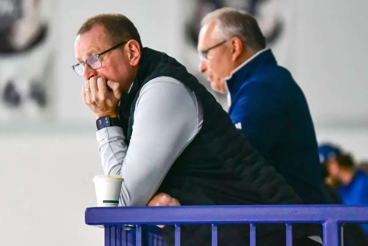 Toronto Maple Leafs GM Brad Treliving observes practice with Craig Berube in the background.