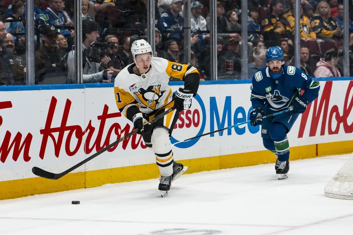Vancouver Canucks forward Conor Garland (8) pursues Pittsburgh Penguins forward Ben Kindel (81) in the second period at Rogers Arena.