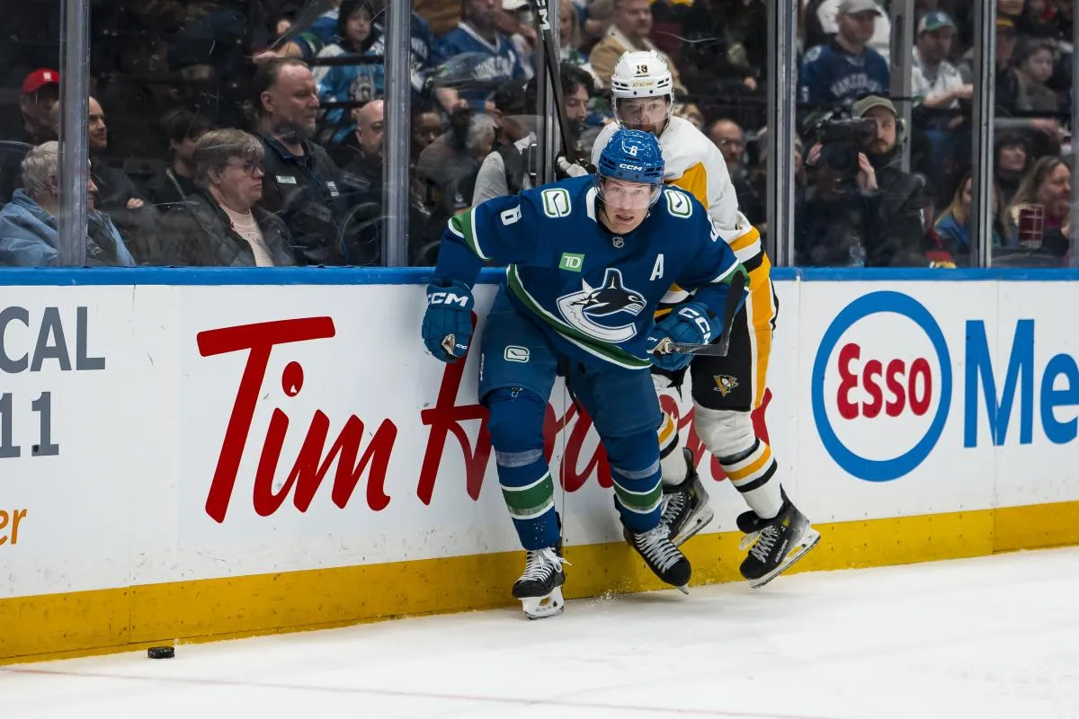Vancouver Canucks forward Brock Boeser (6) checks Pittsburgh Penguins forward Thomas Novak (18) in the second period at Rogers Arena.