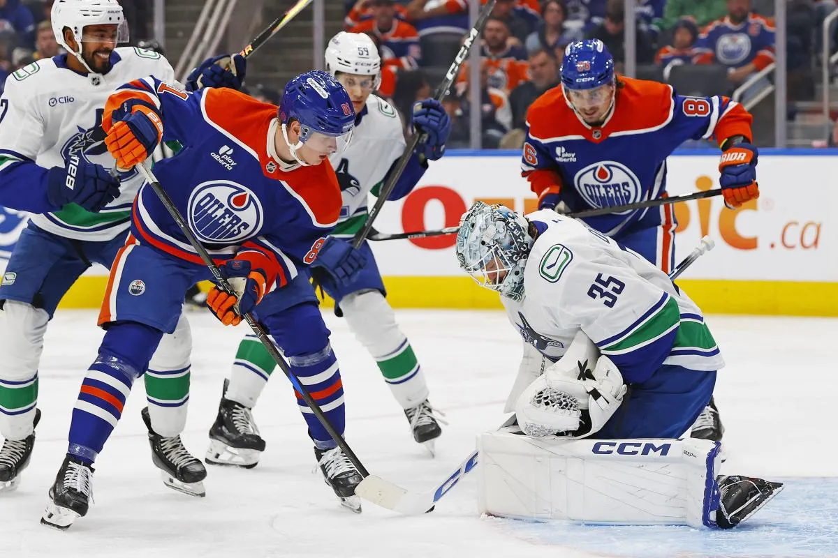 Edmonton Oilers forward Josh Samanski (81) looks for a loose puck in front of Vancouver Canucks goaltender Thatcher Demko (35) during the third period at Rogers Place.