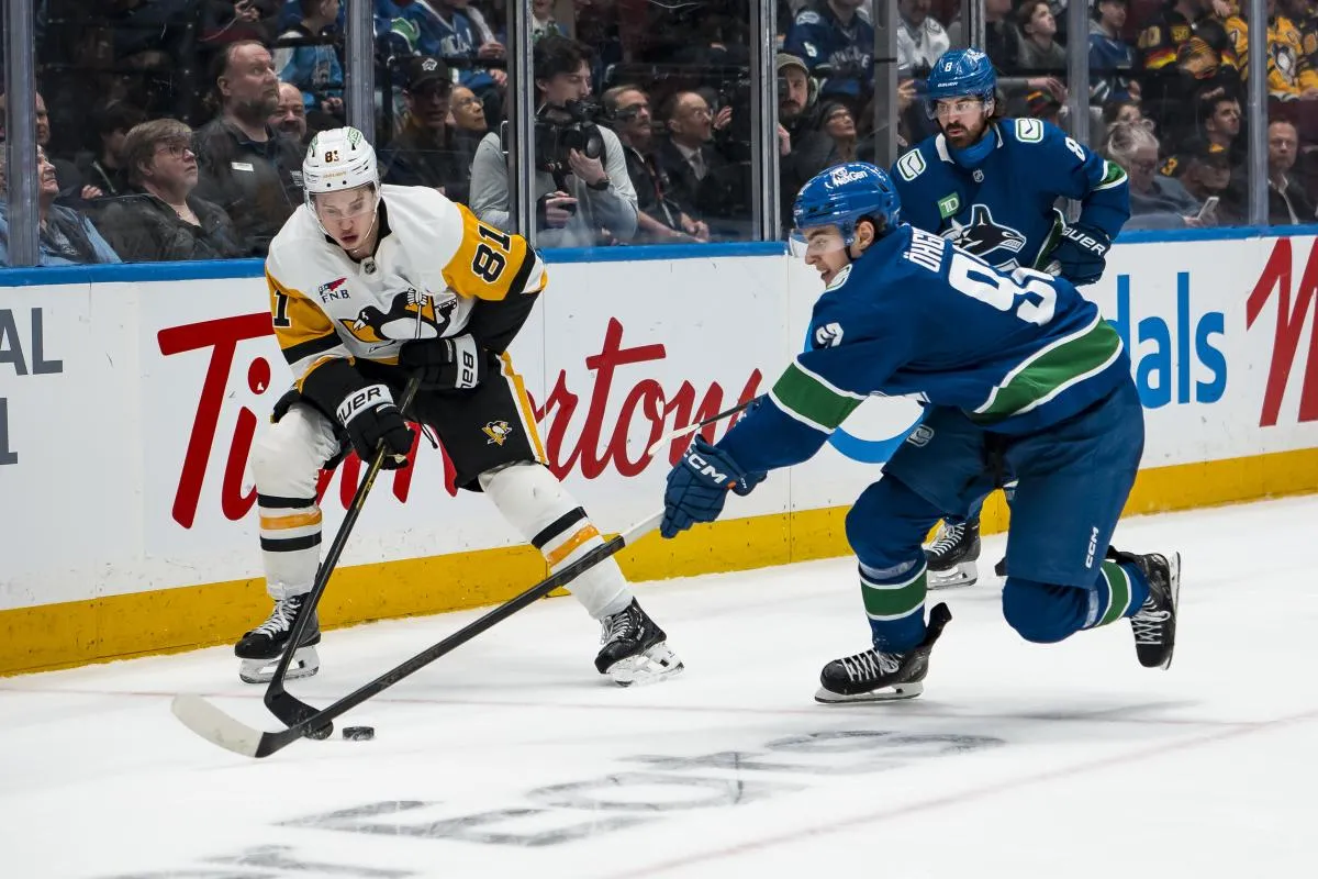 Vancouver Canucks forward Conor Garland (8) watches as forward Liam Ohgren (92) stick checks Pittsburgh Penguins forward Ben Kindel (81) in the second period at Rogers Arena.