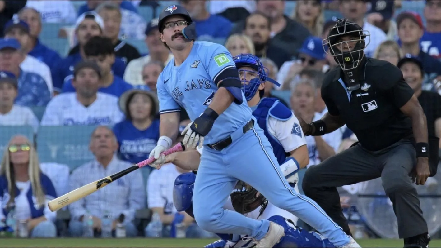 Toronto Blue Jays left fielder Davis Schneider (36) hits a home run against the Los Angeles Dodgers in the first inning during game five of the 2025 MLB World Series at Dodger Stadium.