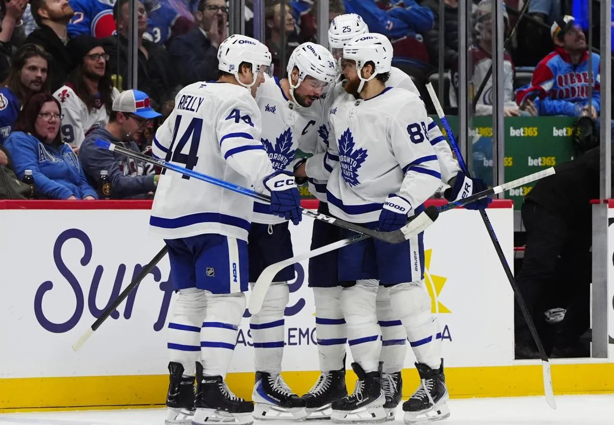 Toronto Maple Leafs center Auston Matthews (34) celebrates his goal with defenseman Morgan Rielly (44),right wing William Nylander (88), and defenseman Brandon Carlo (25) in the third period against the Colorado Avalanche at Ball Arena.
