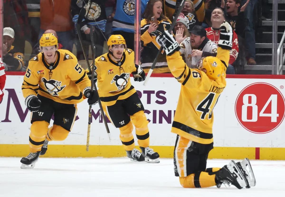 Pittsburgh Penguins center Noel Acciari (55) and center Connor Dewar (19) react to a goal by center Blake Lizotte (46) during the third period against the Detroit Red Wings at PPG Paints Arena.