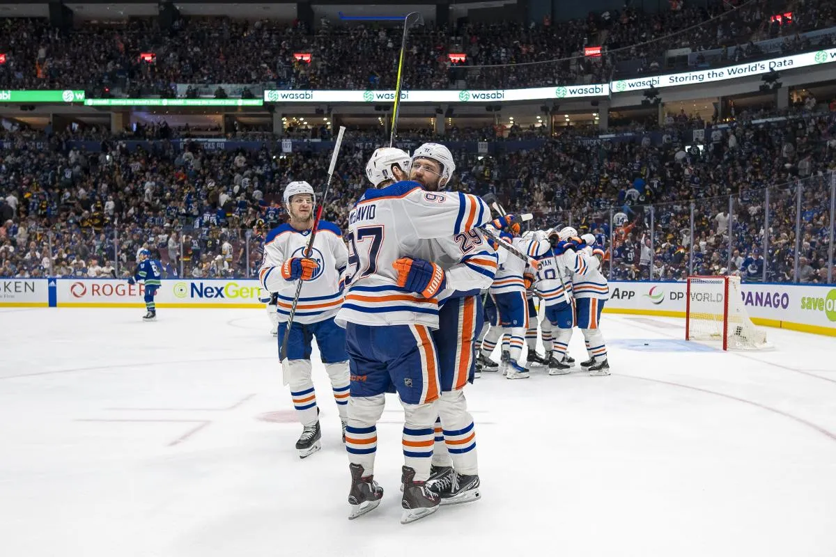 Edmonton Oilers forward Mattias Janmark (13) and forward Leon Draisaitl (29) and forward Connor McDavid (97) celebrate their victory against the Vancouver Canucks during the first overtime in game two of the second round of the 2024 Stanley Cup Playoffs at Rogers Arena.