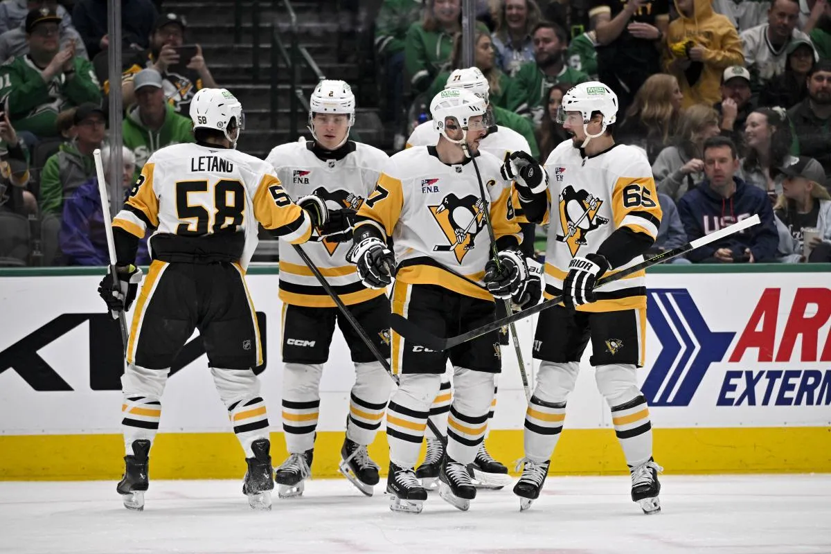 Pittsburgh Penguins defenseman Kris Letang (58) and ight wing Rutger McGroarty (2) and center Evgeni Malkin (71) and defenseman Erik Karlsson (65) celebrate after Penguins center Sidney Crosby (87) scores a power play goal against the Dallas Stars during the first period at the American Airlines Center.