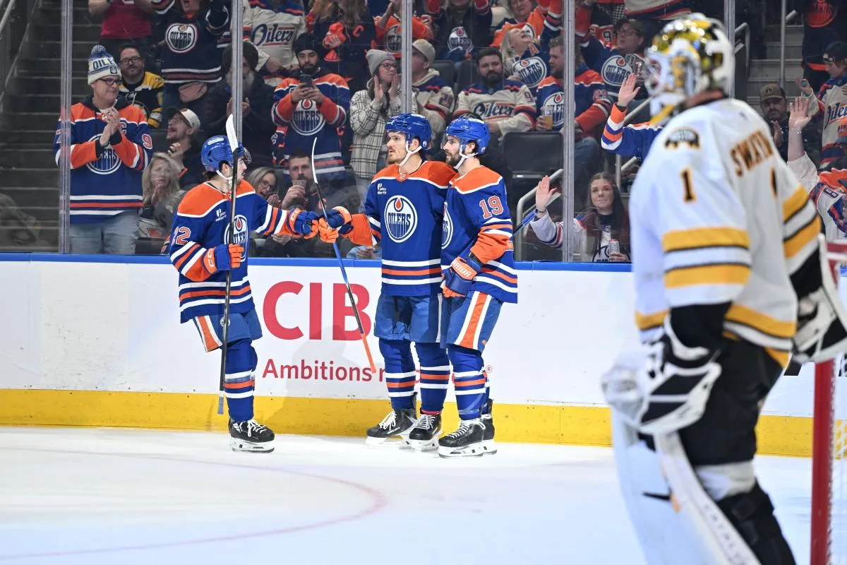 Edmonton Oilers center Matt Savoie (22) celebrates a goal with center Jack Roslovic (28) center Adam Henrique (19) in the third period against the Boston Bruins at Rogers Place.