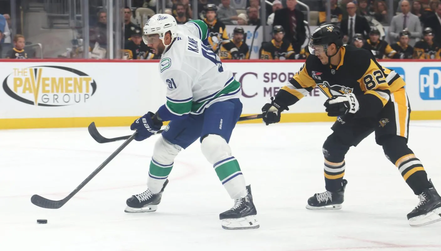 Vancouver Canucks left wing Evander Kane (91) skates with the puck ahead of Pittsburgh Penguins defenseman Caleb Jones (82) during the first period at PPG Paints Arena.