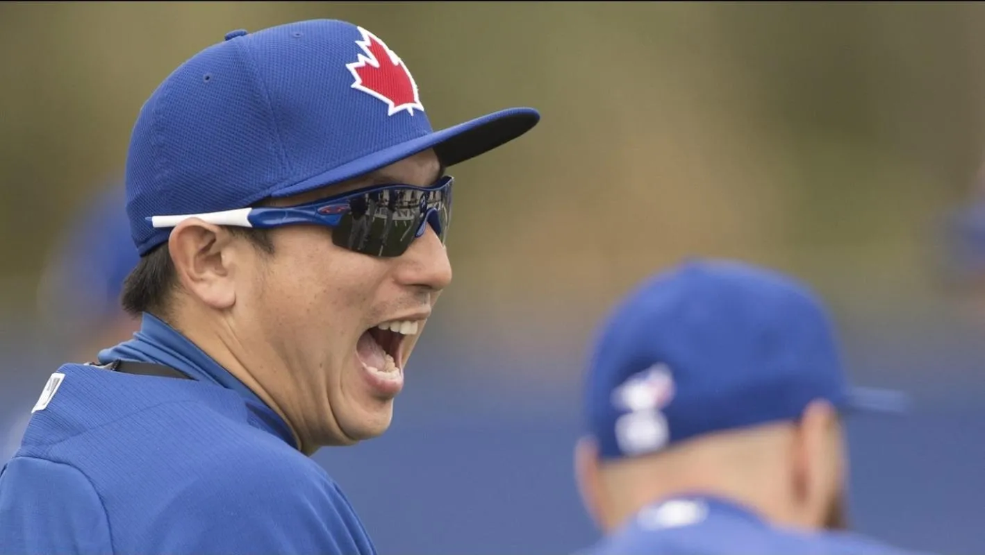 Toronto Blue Jays infielder Munenori Kawasaki (66) jokes with teammates during morning workouts at Bobby Mattick Training Center.