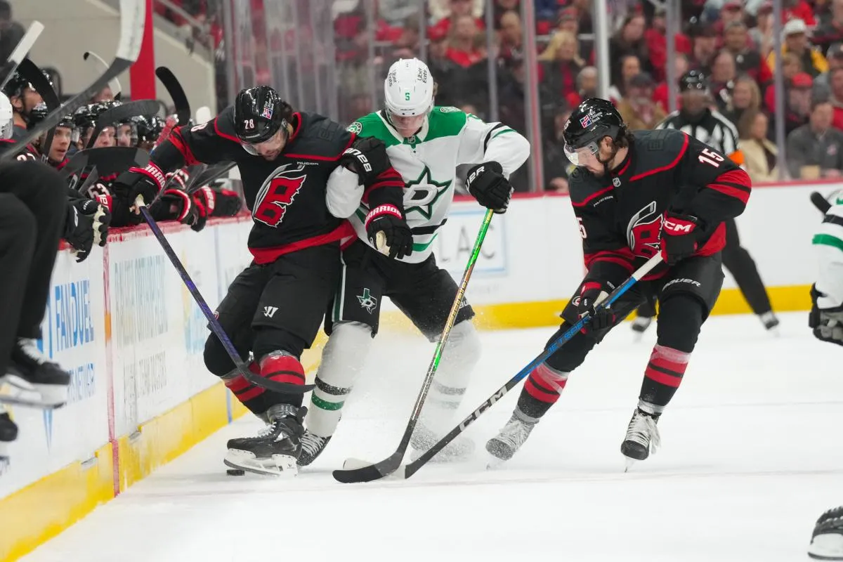 Carolina Hurricanes left wing William Carrier (28) and center Noah Philp (15) battle for the puck against Dallas Stars defenseman Nils Lundkvist (5) during the first period at Lenovo Center.