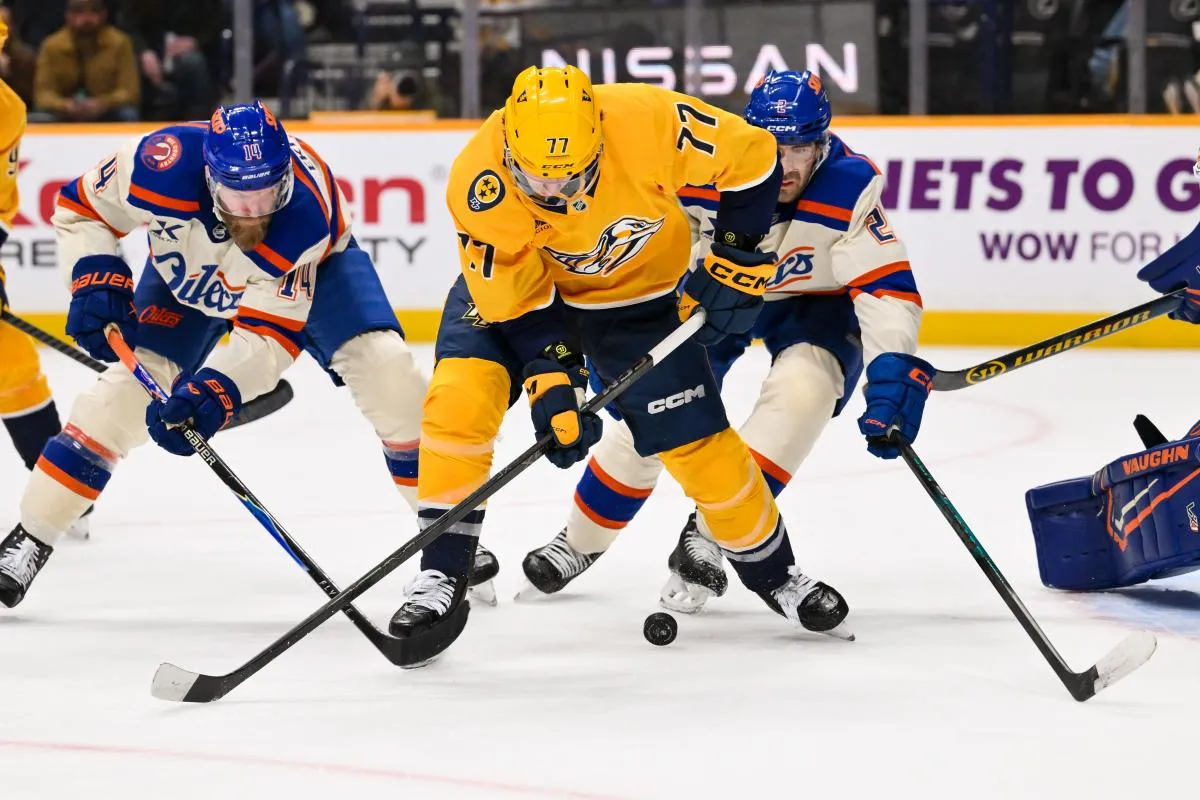 Nashville Predators right wing Luke Evangelista (77) and Edmonton Oilers defenseman Mattias Ekholm (14) battle for the puck during the third period at Bridgestone Arena.