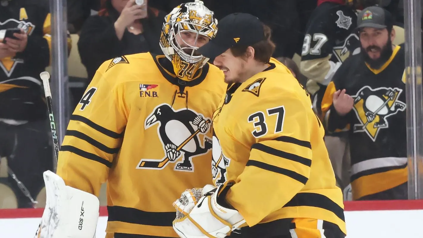 Pittsburgh Penguins goaltenders Stuart Skinner (74) and Arturs Silovs (37) react after defeating the Philadelphia Flyers at PPG Paints Arena.