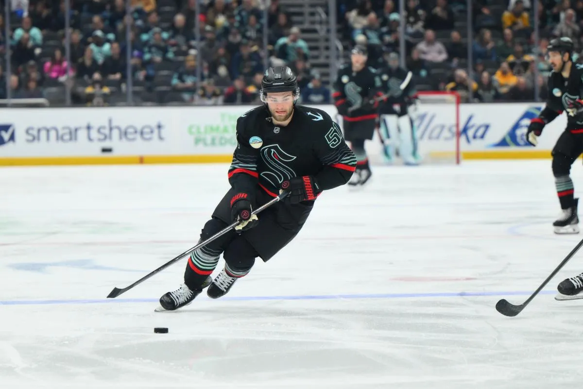 Seattle Kraken center Shane Wright (51) advances the puck against the Boston Bruins during the second period at Climate Pledge Arena.