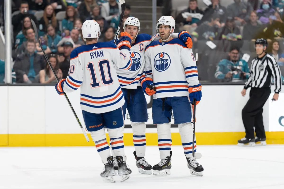 Edmonton Oilers center Derek Ryan (10) celebrates with center Connor McDavid (97) and defenseman Evan Bouchard (2) during the first period against the San Jose Sharks at SAP Center at San Jose.