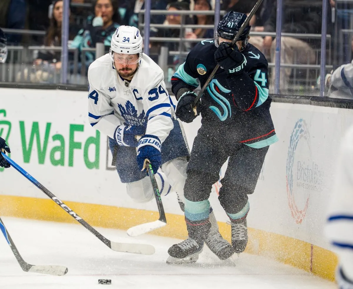 Toronto Maple Leafs forward Auston Matthews (34) battles Seattle Krakendefenseman Ryker Evans (41) for the puck during the third period at Climate Pledge Arena.