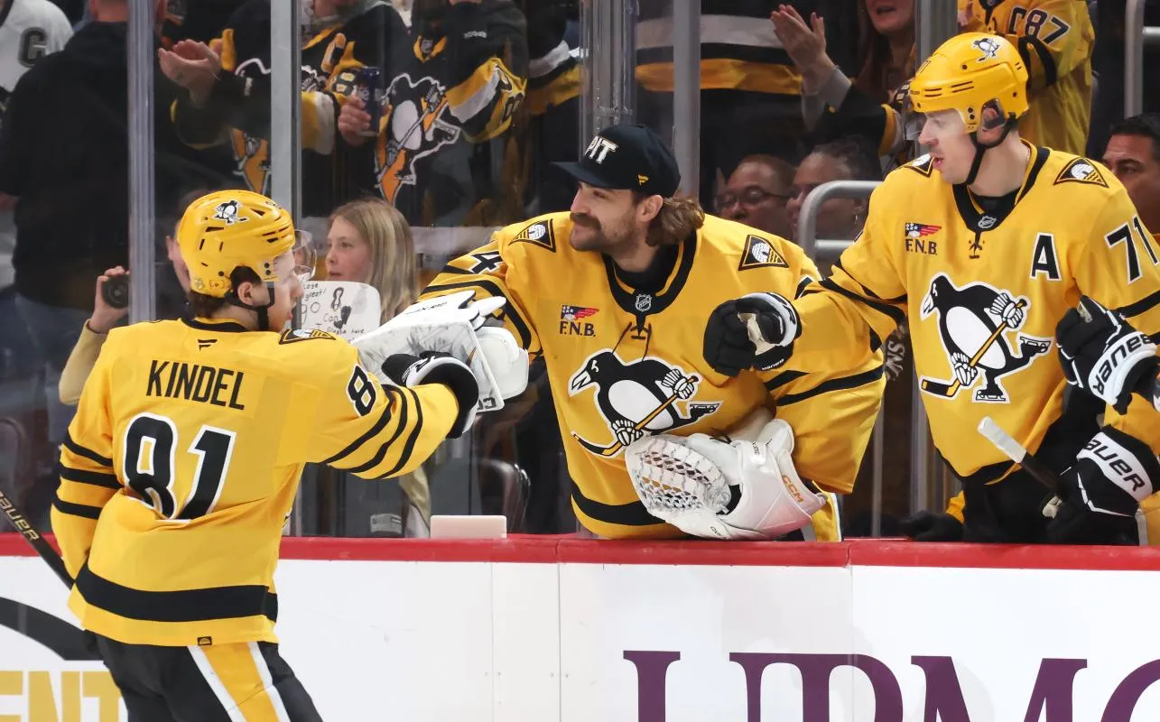 Pittsburgh Penguins center Ben Kindel (81) celebrates his goal with goaltender Stuart Skinner (74) and center Evgeni Malkin (71) at the bench against the Chicago Blackhawksduring the second period at PPG Paints Arena.