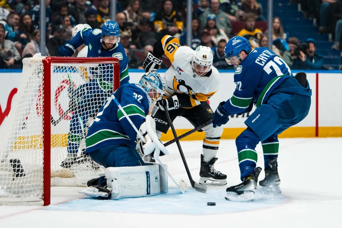 Vancouver Canucks goalie Kevin Lankinen (32) watches as forward Filip Chytil (72) battles with Pittsburgh Penguins forward Blake Lizotte (46) in the third period at Rogers Arena.