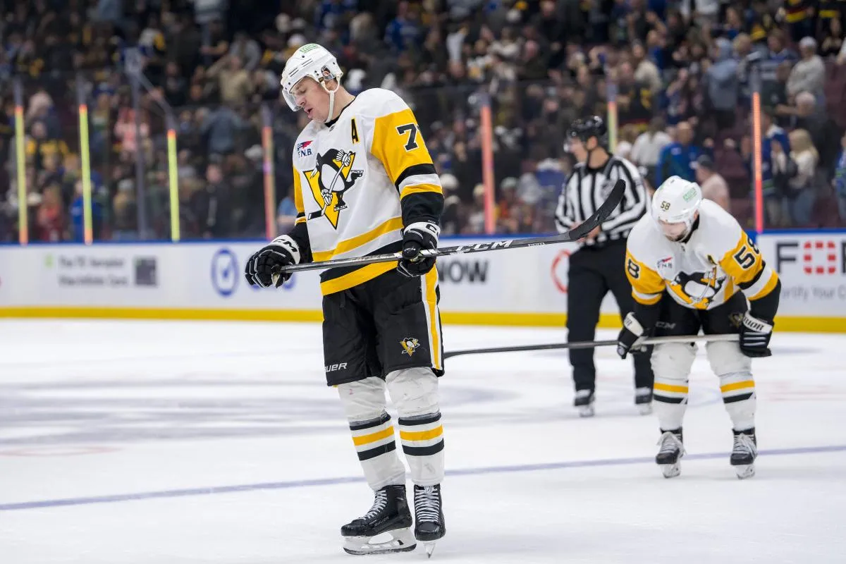 Pittsburgh Penguins defenseman Kris Letang (58) and forward Evgeni Malkin (71) react after losing to the Vancouver Canucks at Rogers Arena.