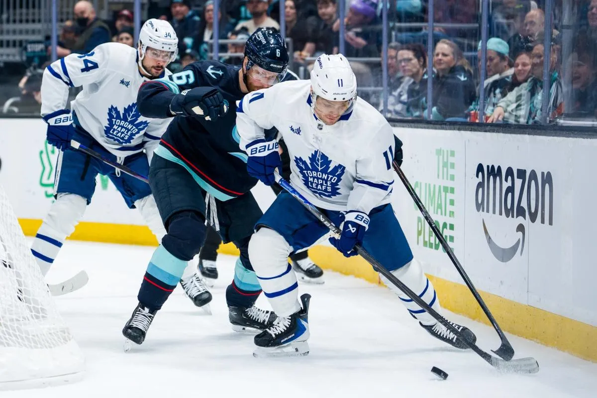 Toronto Maple Leafs forward Max Domi (11) battles Seattle Kraken defenseman Adam Larsson (6) during the first period at Climate Pledge Arena.